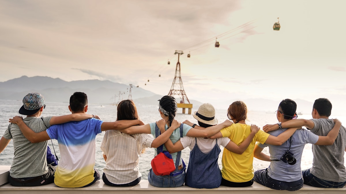 A group sitting together with arms around each other